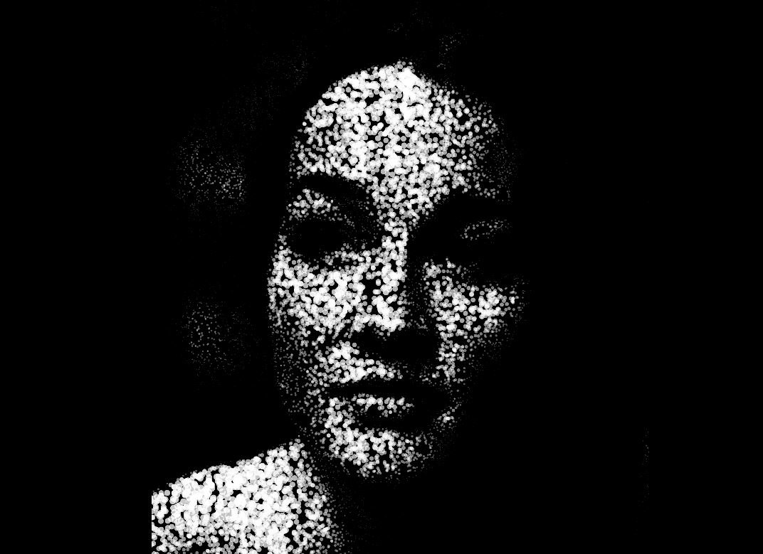 A woman's face made only with animated particles